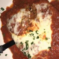 Veal Parmigiana · Veal cutlet topped with marinara sauce and mozzarella.