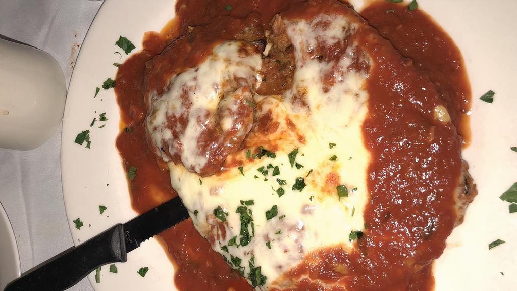 Veal Parmigiana · Veal cutlet topped with marinara sauce and mozzarella.