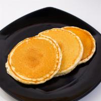Buttermilk Pancakes Breakfast · Three large, fluffy pancakes served with butter and syrup.