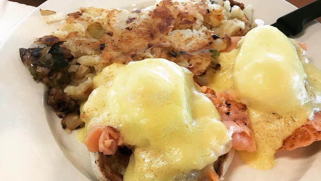 Eggs Benedict · Two poached eggs on an English muffin topped with hollandaise sauce, with home fries.