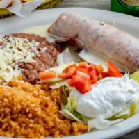 Chimichangas · Two flour tortillas, soft or fried filed with shredded beef chicken, topped with cheese sauc...