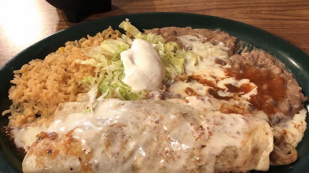 El Burrito Ranchero · Two burritos filled with fried chicken and cheese, topped with cheese sauce, burrito sauce, pico de gallo and rice or beans.