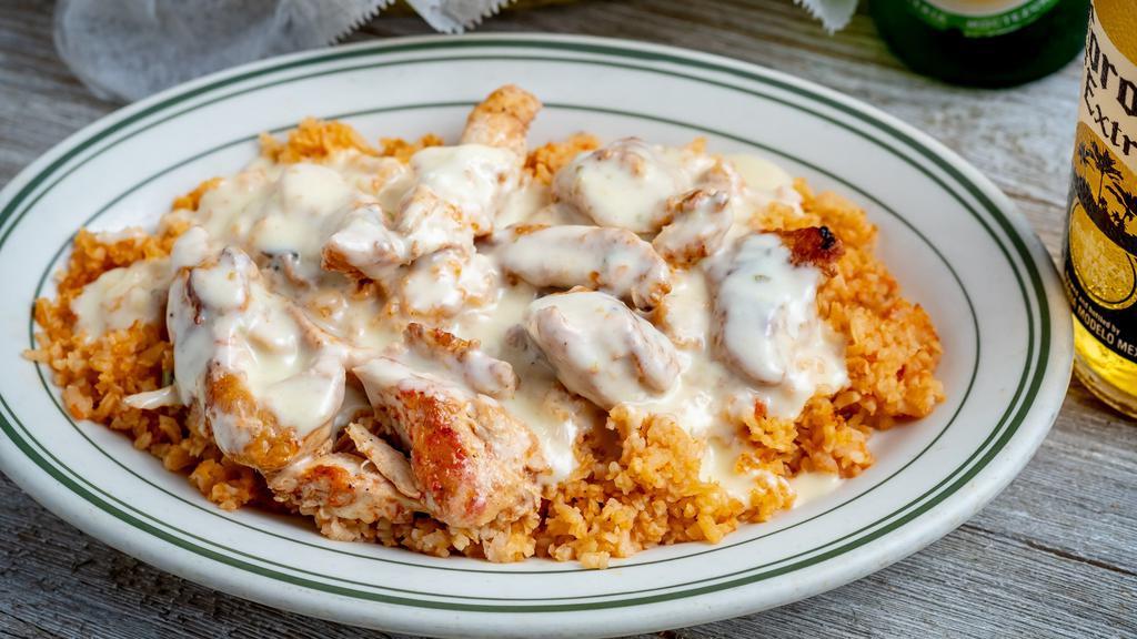 Arroz Con Pollo · Rice with chilled chicken, bell peppers, onions, tomatoes, topped with cheese sauce.
