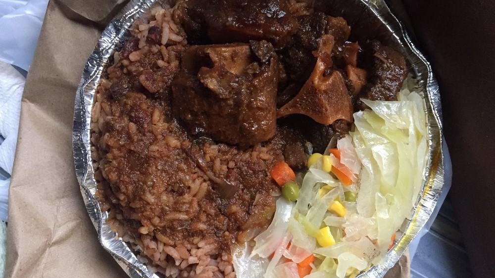 Oxtail · A Caribbean favorite braised in its own natural gravy with onions, peppers, butter beans, and spinners