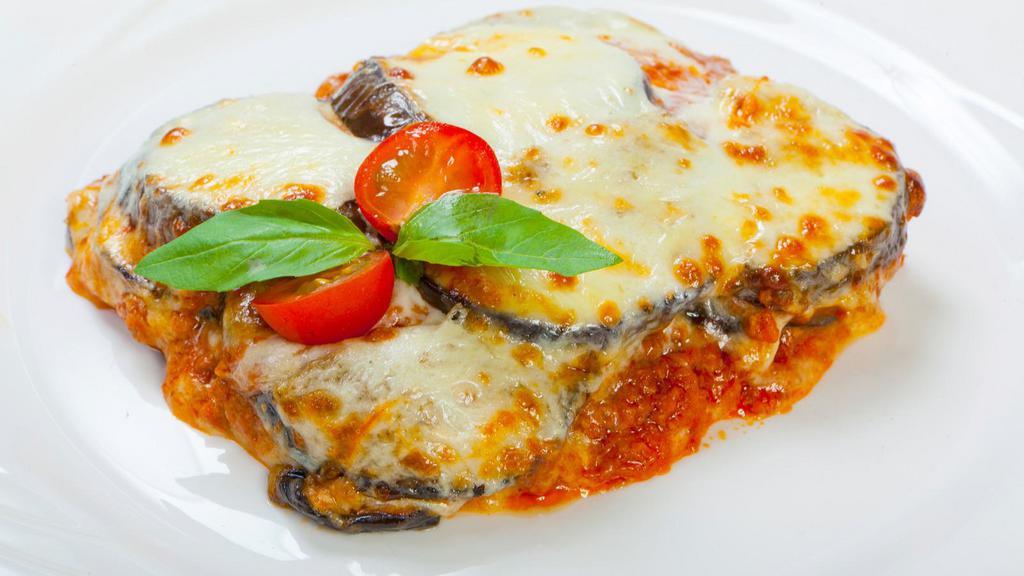 Eggplant Parmigiana · Sliced eggplant covered with savory marinara sauce and creamy cheese and served with side dish of choice.