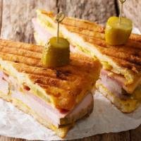 Cuban Sandwich · Hearty pork, ham, swiss cheese, pickles, and mustard on toasted garlic hero with beverage of...