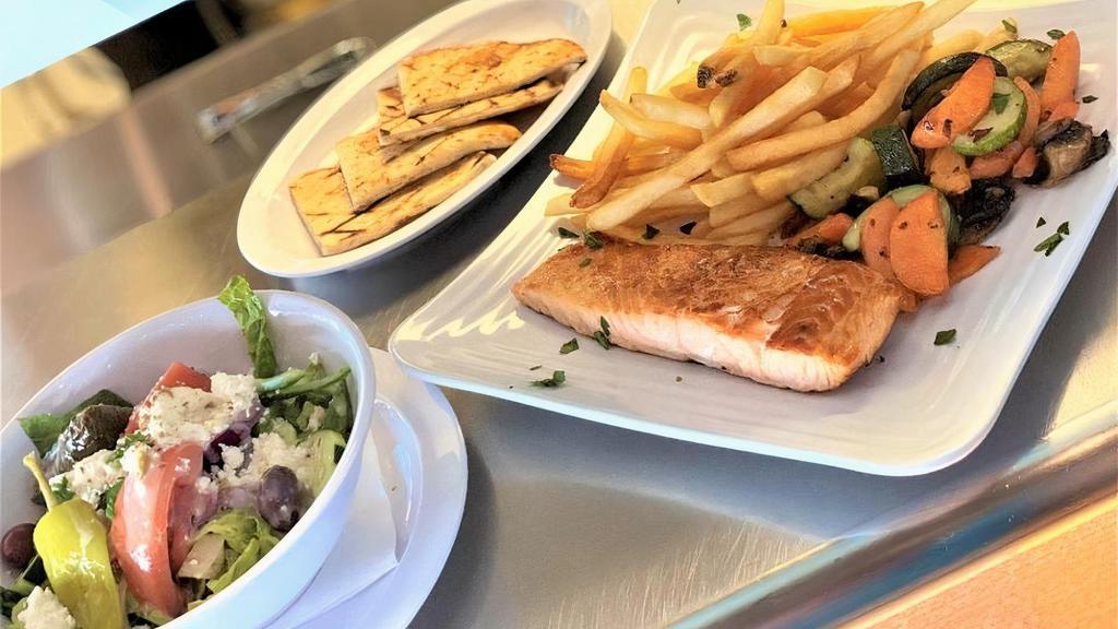 Wild Caught Salmon · with herbs, olive, oil, and lemon. Includes a Greek salad, choice of fries, lemon potatoes or rice, and a mixed vegetable.