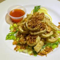 Fried Calamari · Sweet Chili Sauce, Lime Wedge, Thai Basil, Topped with Fried Garlic and Shallots.