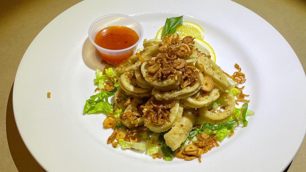 Fried Calamari · Sweet Chili Sauce, Lime Wedge, Thai Basil, Topped with Fried Garlic and Shallots.