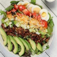Cobb · Mixed greens, Mexican cheese blend, tomatoes, hard boiled eggs*, bacon bits, avocado, celery...