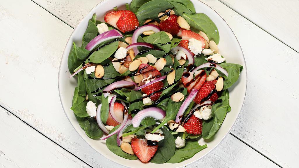 Berry Spinach · Spinach, red onions, strawberries, roasted almonds, feta cheese, and raspberry-balsamic vinaigrette