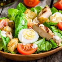 Grilled Chicken Salad · Grilled chicken slices topped with mixed greens, boiled eggs, tomatoes, toasted almonds, and...
