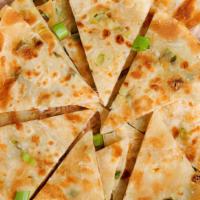 Scallion Pancake · Scallion pancake, is a chinese, savory, unleavened flatbread folded with oil and minced scal...