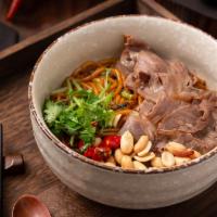 Braised Rice Noodle · Contains sliced beef, cilantro, peanuts and hot red peppers. Spicy.