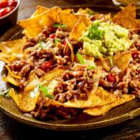 Nachos · Crispy corn tortillas smothered in melty cheese and topped with sour cream, black olives and...
