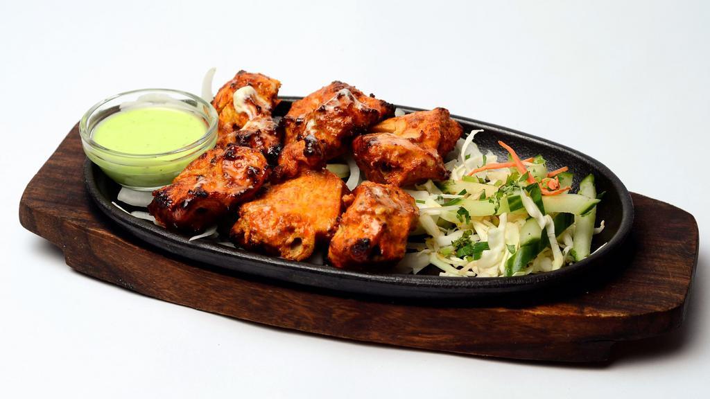 Sizzling Chicken Tikka Kebab · Perfect oven-roasted chicken marinated in yogurt, lime juice, and aromatic spices.