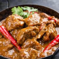 Authentic Lamb Vindaloo · Fiery marinated lamb cooked in a highly flavorful spicy mixture and vinegar.