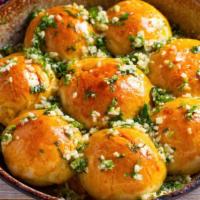 Garlic Knots · Fresh oven-baked bread knots sprinkled with garlic and butter.