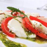 Caprese Salad · Fresh salad made with mozzarella, vine ripened tomato and fresh basil.