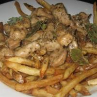 Tigania · Strips of pork with bay leaf, wine sauce and Greek fries.