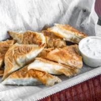 Spanakopita Bites. · Flaky phyllo sheets layered with savory spinach and feta cheese filling with a side of our f...