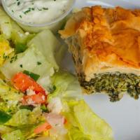 Spanakopita. · Flaky phyllo sheets layered with a savory spinach and feta cheese filling