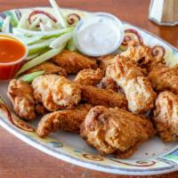 Buffalo Wings  · Most popular. Twelve chicken wings tossed in a mild buffalo sauce served with Bleu cheese.