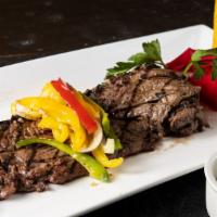 Argentinean Churrasco · Argentinian skirt steak w/ sauteed peppers, onions, chimichurri sauce