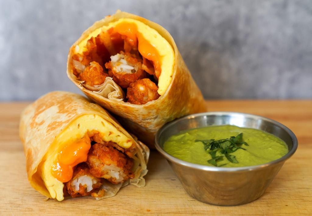 Bacon, Egg And Cheddar Burrito · 3 fresh cracked cage-free scrambled eggs, melted Cheddar cheese, smokey bacon, crispy potato tots wrapped in a toasted 12” flour tortilla and side of avocado salsa verde
