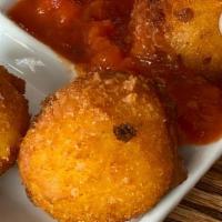 Arancini · fried saffron riceballs stuffed with mozzarella cheese