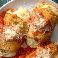 Eggplant Rollatini · Breaded eggplant rolled with spinach ricotta filled topped with tomato sauce and melted mozz...