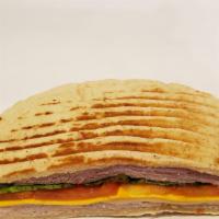Toasted Monte Cristo Panini · Toasted Monte Cristo: Layers of ham, smoked turkey, swiss, cheddar, lettuce, tomato and hone...