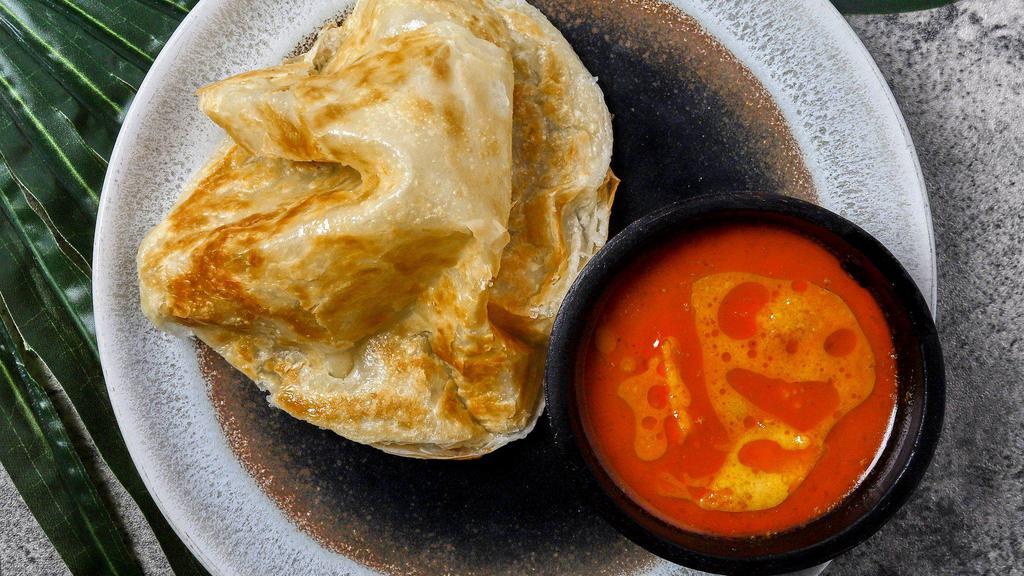 Roti Canai · Crispy fluffy Indian bread served with a curry dipping sauce.