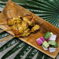 Satay Chicken Skewers · Four grilled chicken skewers marinated with spicy peanut sauce