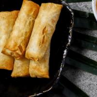 Crispy Vegetable Spring Rolls · Five crispy spring rolls with cabbage, carrot, and mushroom served with sweet chili sauce.