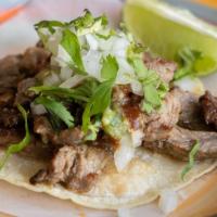 Carne Asada Taco · Grilled steak, red, and green sauce, cilantro, onions.