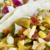 Calabacitas Taco · Zucchini, mushrooms, red, and green peppers, Mexican cheese, pico de gallo, red, and green s...