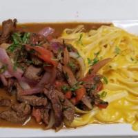 Tallarin A La Huancina Con Lomo Saltado · Spaghetti made with Peruvian yellow pepper cheesy sauce, served with our famous stir fry bee...