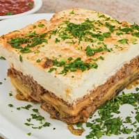 Moussaka · Layers of eggplant, seasoned ground beef, and potatoes topped with bechamel sauce. Served wi...