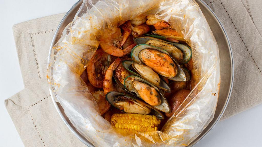 The Perfect Storm · Served with a 1/2 Lb.  of Snow Crab Leg, 1 LB of Head-Off Shrimp, 1/2 LB of Black Mussels. into seafood boil bag with a corn and two potatoes and your favorite sauce