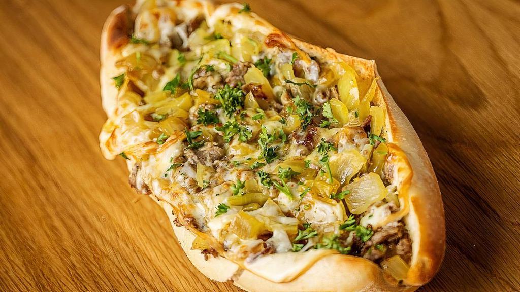 Oui Oui “Wee Wee” · french onion cheesesteak.  french onion soup caramelized onions, shaved ribeye, gruyere cheese, parsley