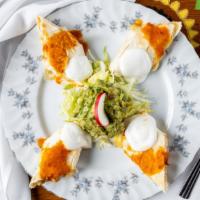 Grilled Chicken Quesados · Flour tortillas filled with cheese and strips of grilled chicken, served with guacomole and ...