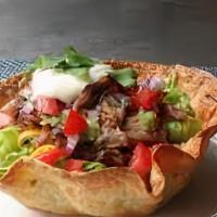 Crispy Tortilla Salad · Vegetarian. Crispy corn tortilla strips, cheese, roasted corn, tomato, carrots, cucumber, wi...