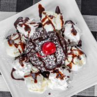 Lava Eruption Cake · With vanilla ice cream, whip cream and chocolate syrup.