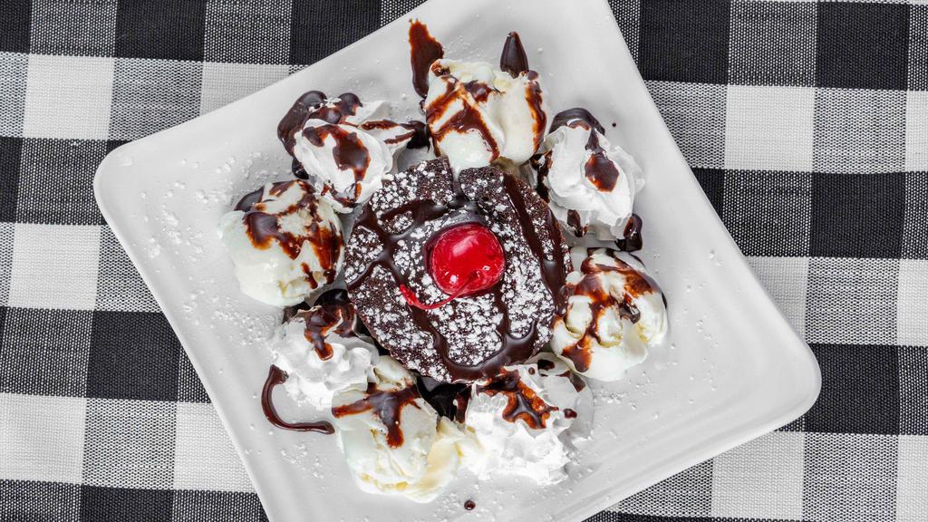 Lava Eruption Cake · With vanilla ice cream, whip cream and chocolate syrup.
