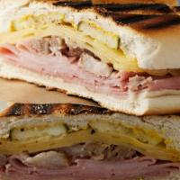 Cuban Sandwich · Shredded roasted Pork, ham. Swiss cheese, pickles and mustard served with a side of fries
