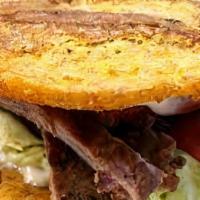 Patacon De Steak  · These patacones use fried plantains as sandwich carriers Filled with steak and cheese top wi...