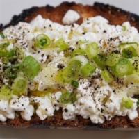 Savory Cottage Toast · Multigrain toast with cottage cheese spread topped with scallions, olive oil and pepper