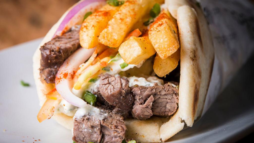 The Steak Gyro · Chef's special steak gyro sliced on warm pita bread with lettuce, tomatoes, onions and tzatziki sauce.