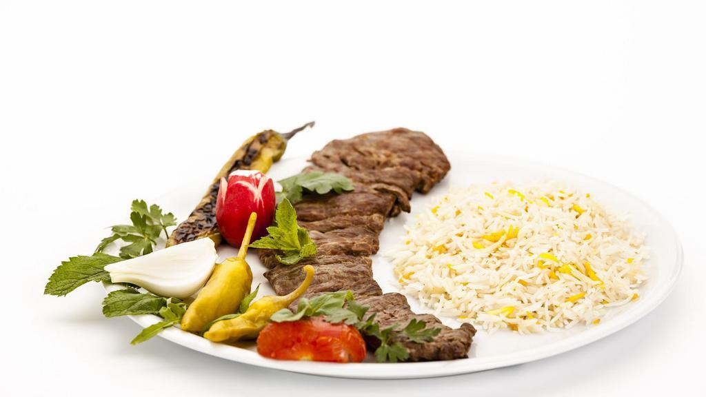 Lamb Kabob Over Rice · House-famous lamb kabobs strips over bed of rice. Served with lettuce, tomatoes, onions and peppers.